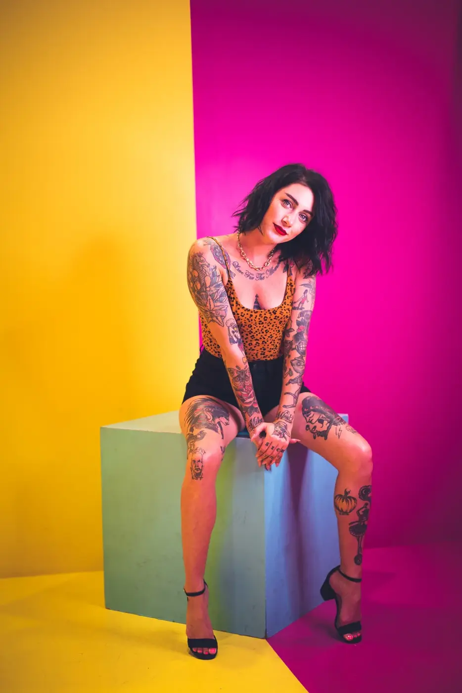Chasen West’s portrait of a woman against vivid pink and yellow walls
